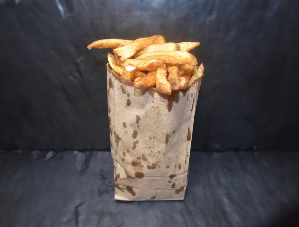 Hand-cut fries in a paper bag